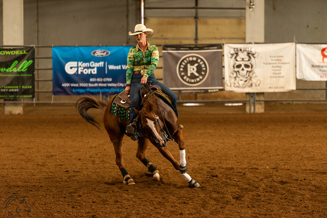 Reining horse and rider performing a spin maneuver